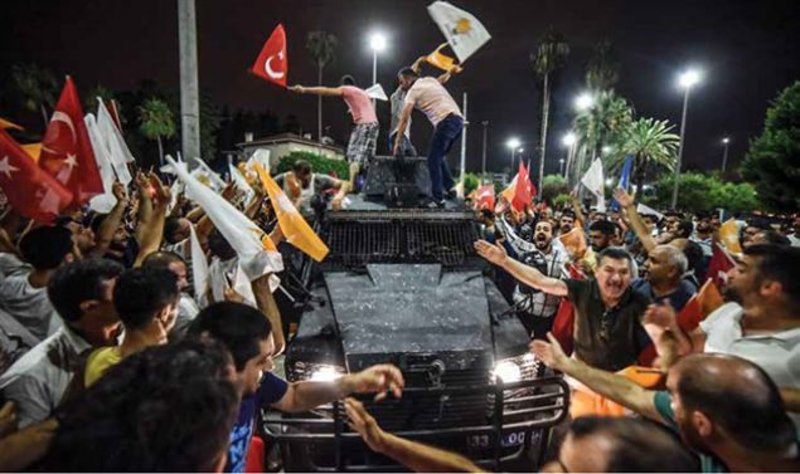 Mersin'de, vatanda�lar ellerinde bayraklarla z�rhl� ara�lar�n �zerine ��karak askeri kalk��may� protesto ettiler.    