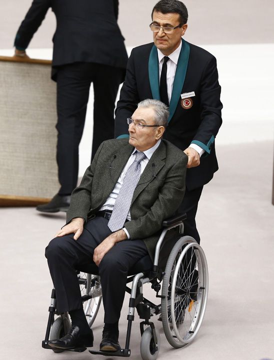  Baykal, tekerlekli sandalyede, grevlilerin yardmyla krsye geldi. Bu arada milletvekilleri Baykal' ayakta alklad. Baykal, krsye gelirken milletvekillerini eliyle selamlad. 